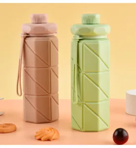 Detail shot of portable collapsible silicone water bottles showcasing geometric texture and hanging strap.