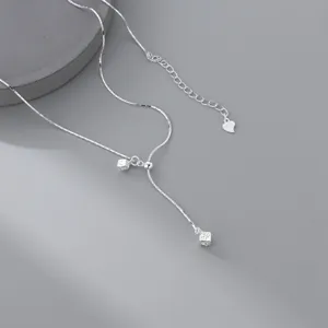 Detailed close-up shot of the sterling silver Y necklace highlighting the textured square pendant.
