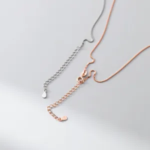 Detail shot of delicate s925 silver and rose gold box chain necklaces with extension.