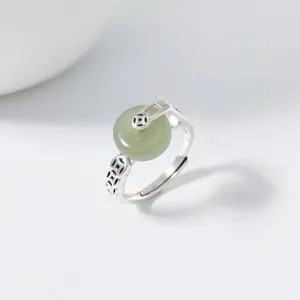Detailed view of the Chinese vintage S925 silver Hetian green jade peace buckle ring.
