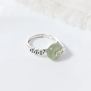 Detailed view of Chinese vintage S925 silver Hetian green jade peace buckle rotating ring.