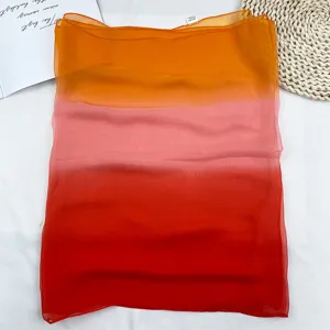 Detailed shot of the lightweight gradient chiffon scarf showing soft fabric texture.