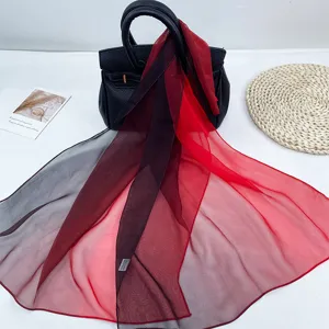 Detail view of a soft breathable rainbow gradient chiffon silk scarf, perfect for sun protection.