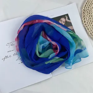 Gradient chiffon silk scarf detail showing soft fabric texture and elegant rolled rose shape.