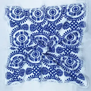 Blue and white floral pattern silk square scarf detail showing elegant lace trim and soft fabric texture.