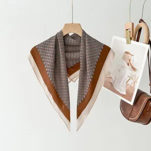 Close-up view of the vintage brown geometric print square scarf hanging on a wooden hanger.