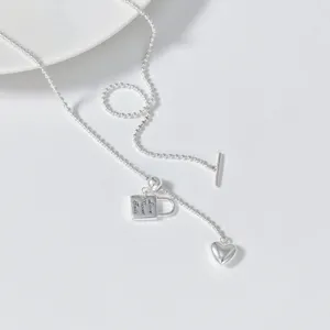 Detail view of S925 silver lariat necklace with heart lock pendant and delicate bead chain.