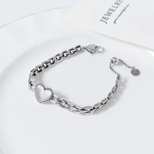 Detailed shot of the silver heart link bracelet, showing delicate Thai silver texture and clasp.