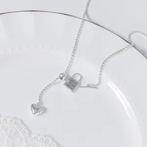 Silver heart lock y-necklace detail shot showcasing the delicate bead chain and pendant.