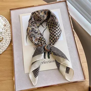 Detail shot of retro silk scarf with paisley and houndstooth pattern, elegant and chic.