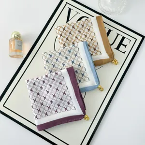 Elegant printed square scarf with chic monogram pattern and metal pendant for daily styling.