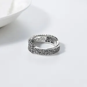 Exquisite detail view of vintage silver spinner ring with traditional carved motifs and patterns.