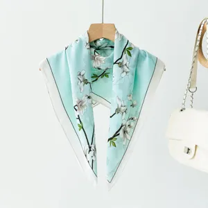 Light blue floral square scarf detail, elegant magnolia print design, versatile fashion accessory.