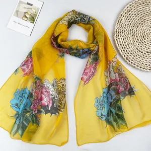 Detailaufnahme des gelben Chiffonschals mit Pfingstrosenmuster und weicher, leichter Stofftextur.