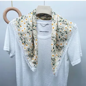 Floral silk square scarf detail featuring delicate white lace trim and daisy print beige.