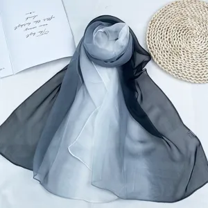 Gradient chiffon scarf detail view, lightweight sheer fabric in elegant black and white tone.