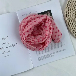 Pink polka dot chiffon scarf detail, lightweight fabric with elegant retro print for summer.