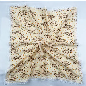 Detailed view of the floral square scarf with delicate white lace trim, lightweight fabric.