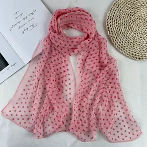 Detailed view of a chic pink polka dot chiffon scarf, lightweight summer sun protection neck wrap.