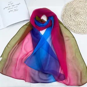 Rainbow gradient chiffon scarf detail showing soft fabric texture and vibrant summer colors.