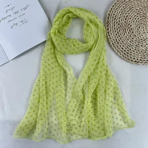 Lightweight green polka dot chiffon scarf for summer fashion styling and sun protection.