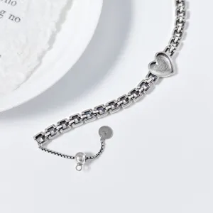 Close-up details of the cool style silver heart watch strap bracelet with adjustable sliding bead.