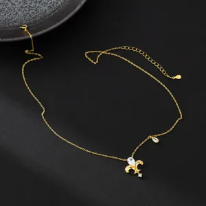 Detail view of gold-plated silver necklace with crystal fleur-de-lis pendant and chain.