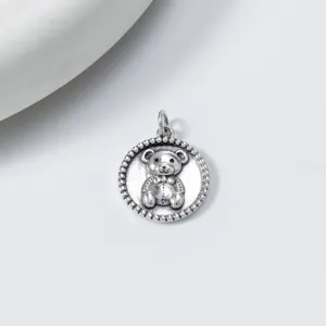 Vintage S925 silver teddy bear round pendant detail, retro thai silver jewelry close up.