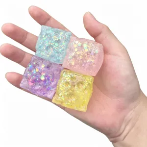 Detailed view of colorful glitter square squeeze toys featuring translucent texture and aurora shimmer.