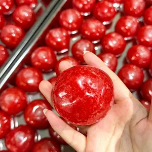 Red fruit slushy handmade stress relief toy, squishy sensory ball with soft texture.