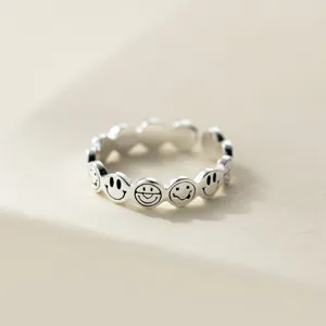 Close-up detail shot of S925 sterling silver retro smiley face open ring, smooth texture.