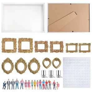 Detaillierte Komponenten der DIY Mini Museums Schattenbox mit goldenen Rahmen und Figuren.
