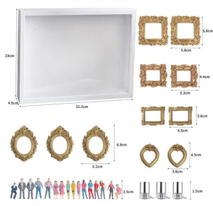 DIY Mini-Museums-Silhouetten-Box Set mit goldenen Miniatur-Bilderrahmen und kleinen Figuren.