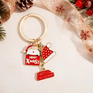 Christmas metal keychain detail showing Santa Claus charm and festive red hat pendants.
