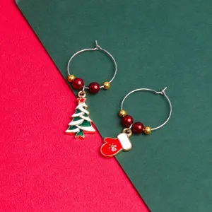 Detailed close-up of Christmas wine glass charms featuring colorful tree and mitten pendants.