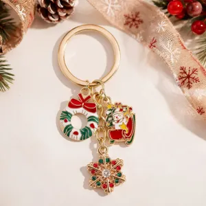 Festive Christmas metal keychain featuring cute Santa Claus and snowflake charms for holiday gifts.