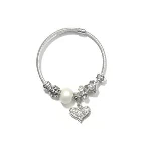 Silver DIY charm bracelet detail, snake chain with pearl and rhinestone heart pendant.