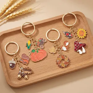 Set of 4 autumn alloy keychains featuring cute pumpkins, squirrels and mushrooms.