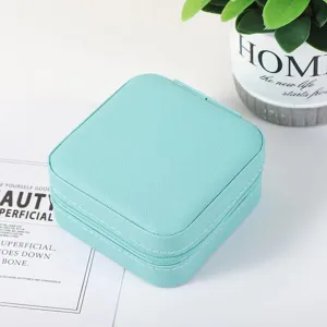 Portable mini jewelry box with zipper pu leather travel storage for rings and earrings.
