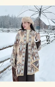 Outdoor detail view of a vintage patterned imitation cashmere shawl in a winter snow scene.