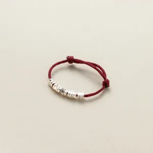 Detailed view of minimalist red string silver nugget ring, chic Chinese style jewelry.