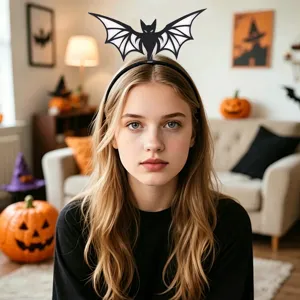 Detail view of the spooky black bat wings headband featuring a festive holiday design.