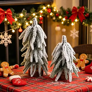 Mini frosted Christmas tree desktop decor with rustic wood base for holiday table and showcase.