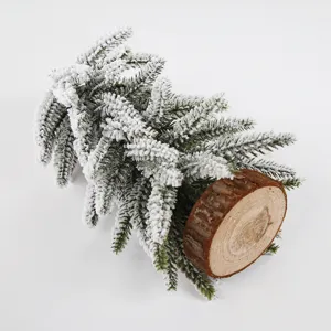 Mini flocked artificial Christmas tree with wood base, detailed view for holiday decor.