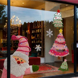 Detailed view of Christmas window stickers featuring pink Santa and trees on glass door.