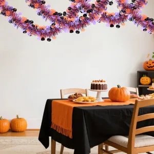 Halloween hanging tinsel garland, black purple orange foil decorations for spooky party scene setup.