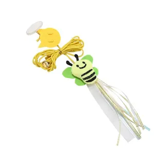 Close-up detail of hanging cat toy with cute bee plush, elastic rope and bell for pet fun.