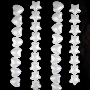 Pearlescent white plastic heart and star hanging string ornament for party background decor.