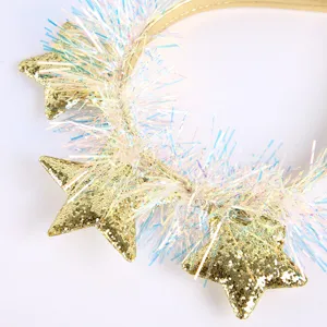 Close-up of gold glitter star headband with colorful shiny tinsel for party hair decoration.