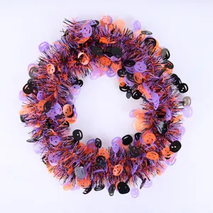 Halloween tinsel garland with pumpkin cutouts, black orange purple festive party decor.